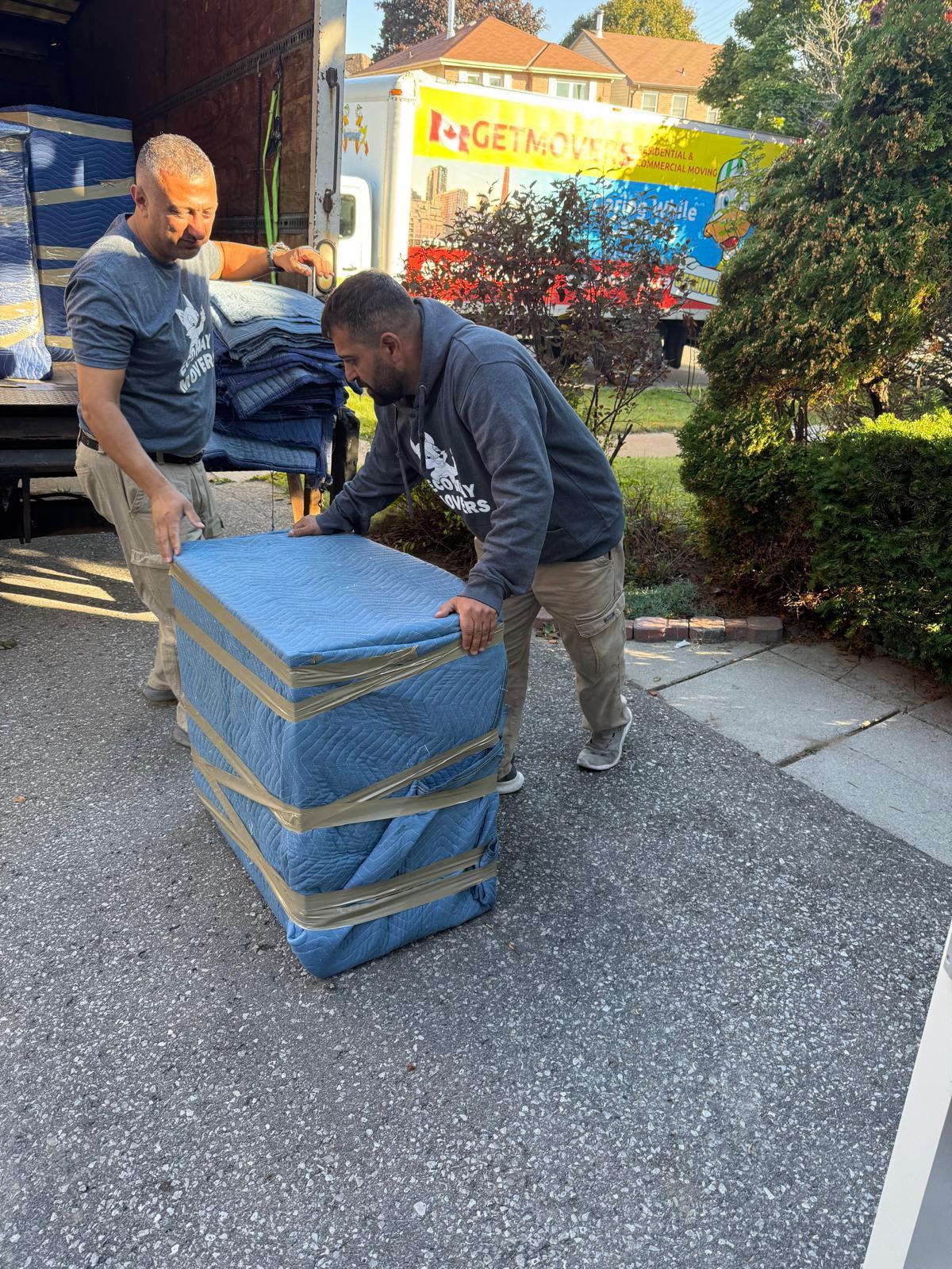 Ecoway Movers crew carefully wrapping furniture