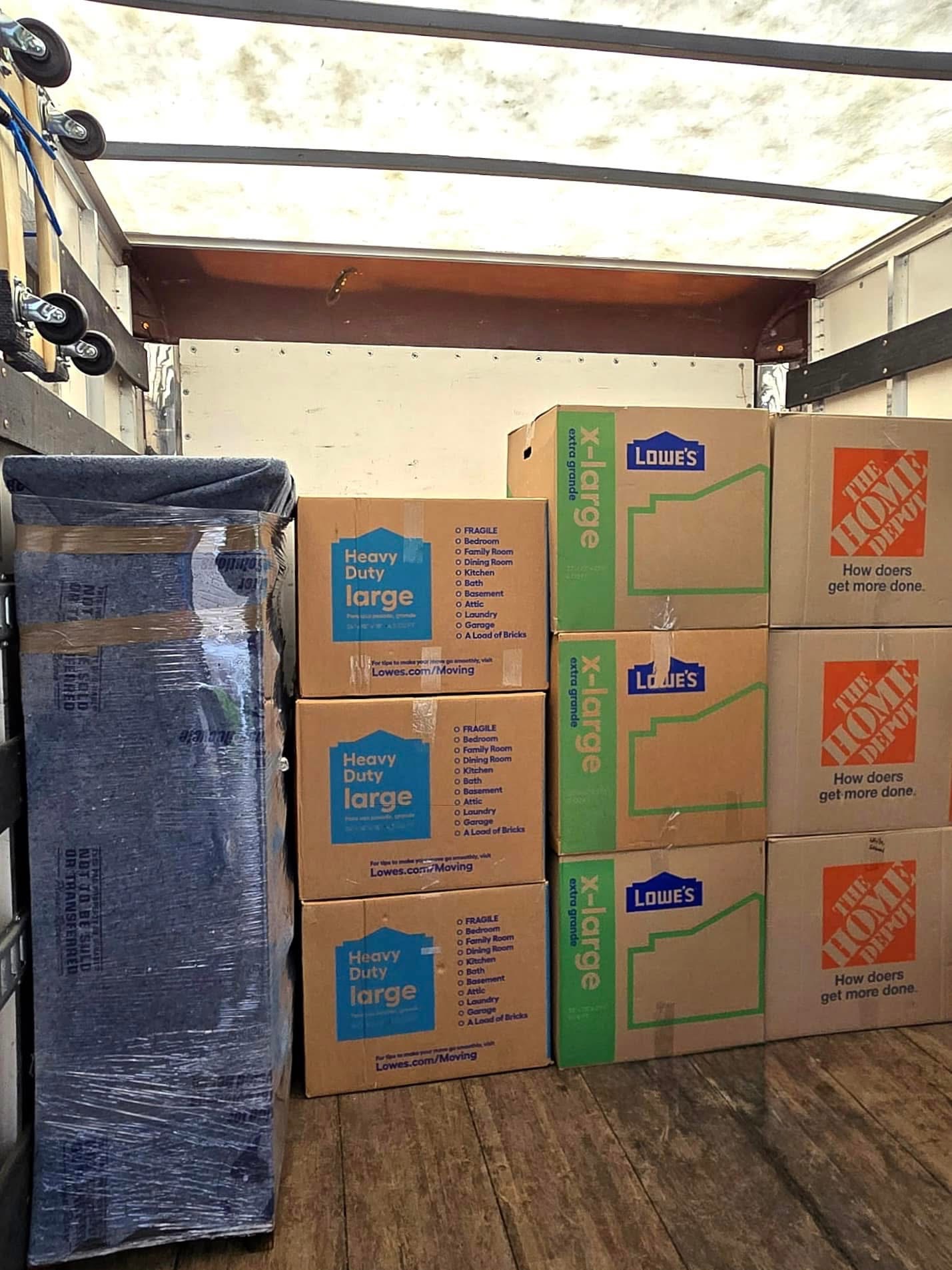 Ecoway Movers team loading boxes into a clean moving truck in the Hespeler Village neighborhood of Cambridge.