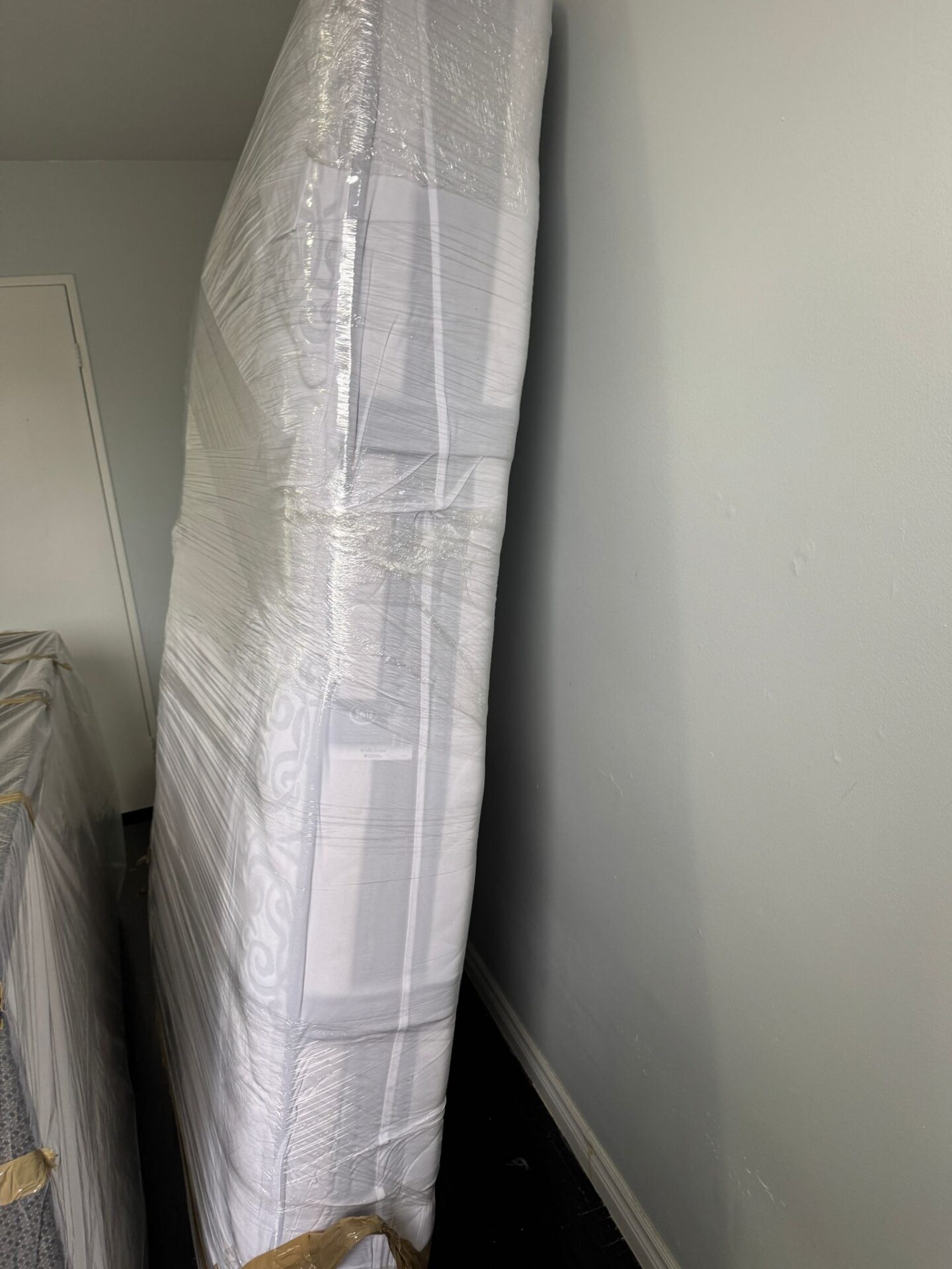 Ecoway Movers Winnipeg MB crew using bubble wrap during professional packing service for a residential move in Winnipeg MB