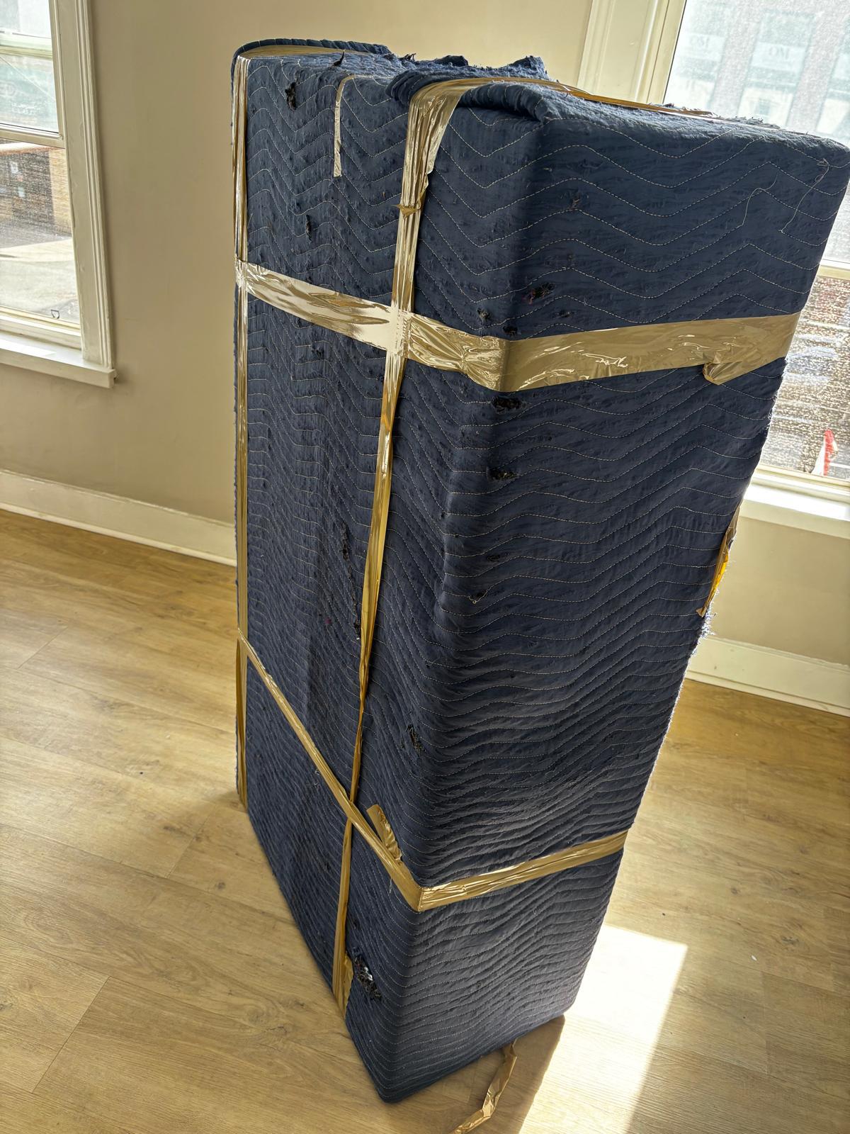 Furniture wrapped with protective moving blankets by Ecoway Movers in Edmonton