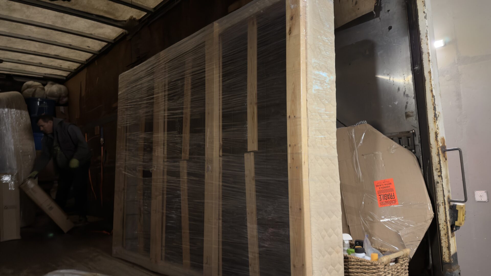Ecoway Movers crew working in condo with elevator padding