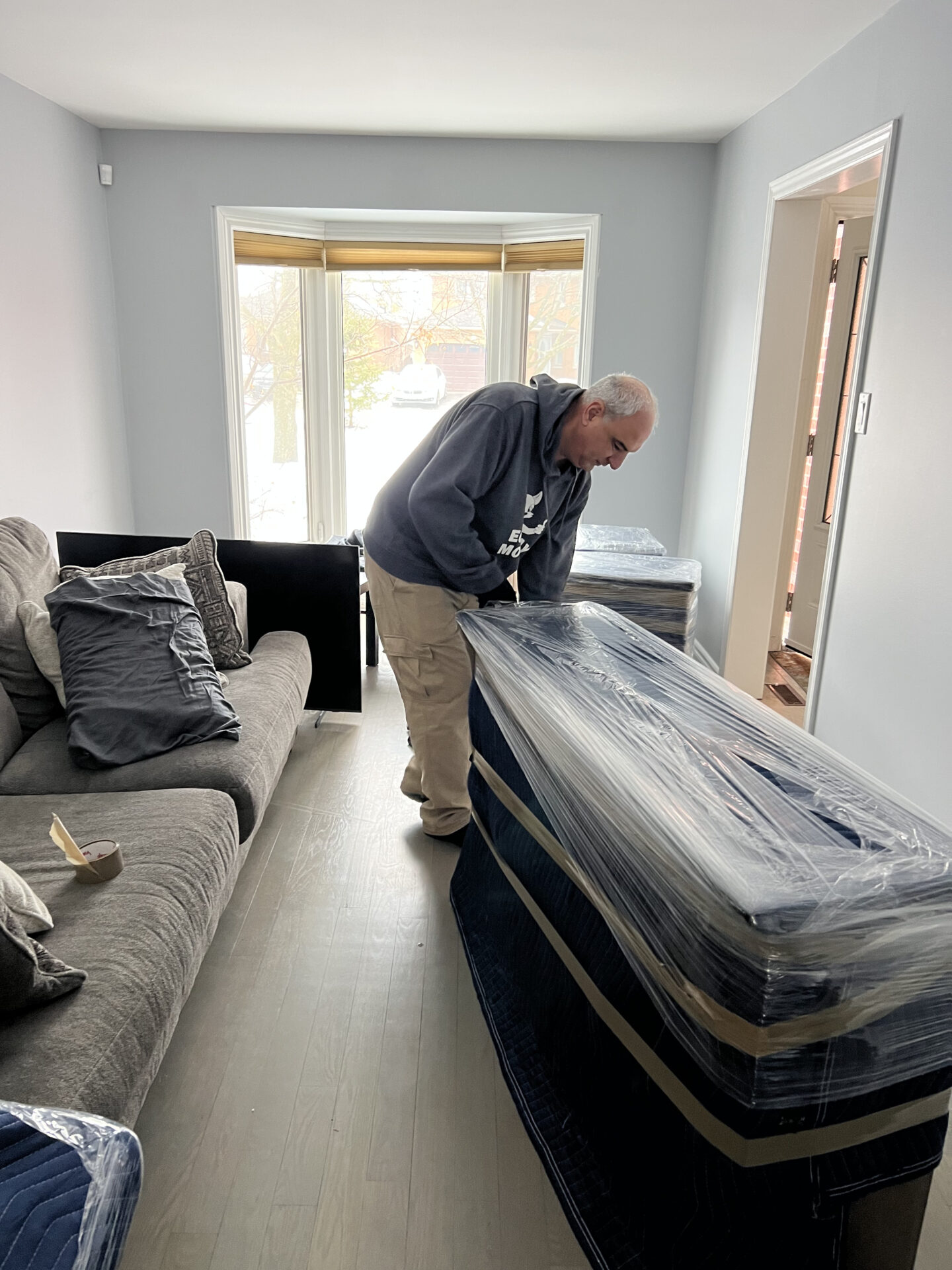 Ecoway Movers Saskatoon SK crew member carefully packing home belongings using professional packing materials and labeling technique during a local Saskatoon residential move