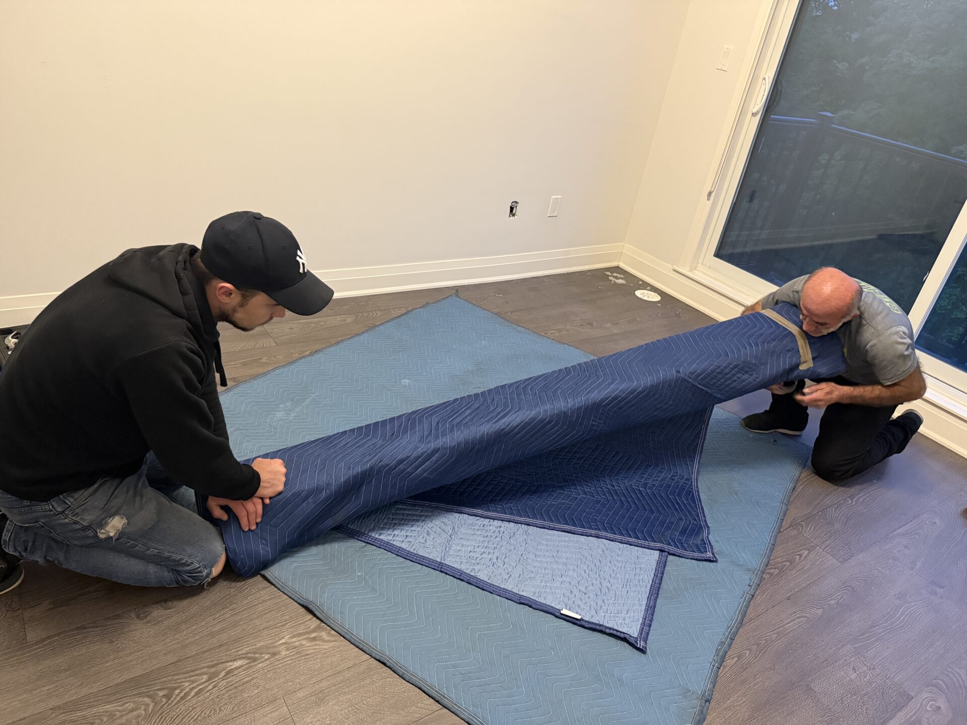 Ecoway Movers laying floor runners and wrapping furniture during Maple Ridge move