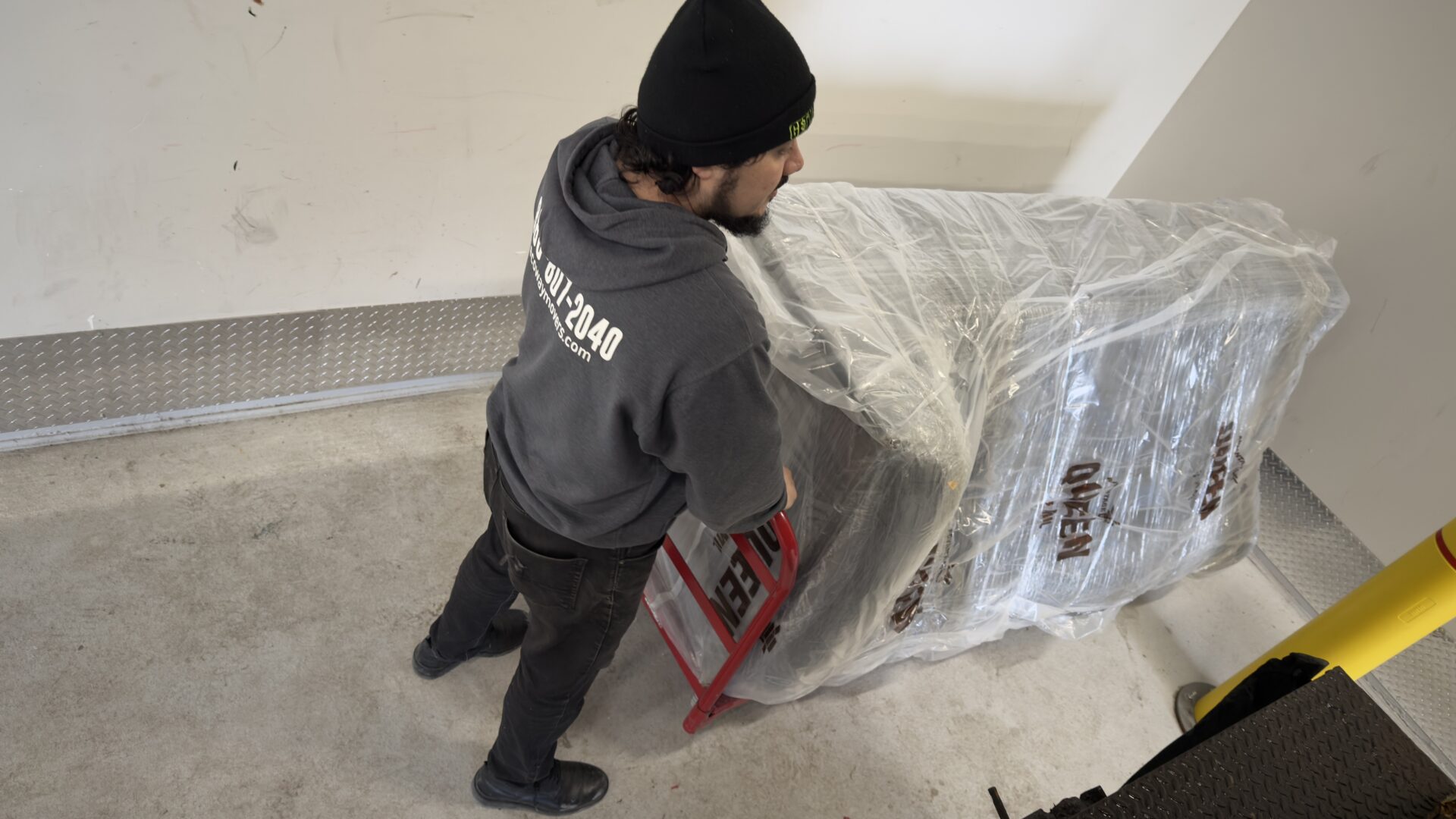 Ecoway Movers Vaughan ON crew carefully packing fragile items during local residential move in Woodbridge with professional wrapping materials