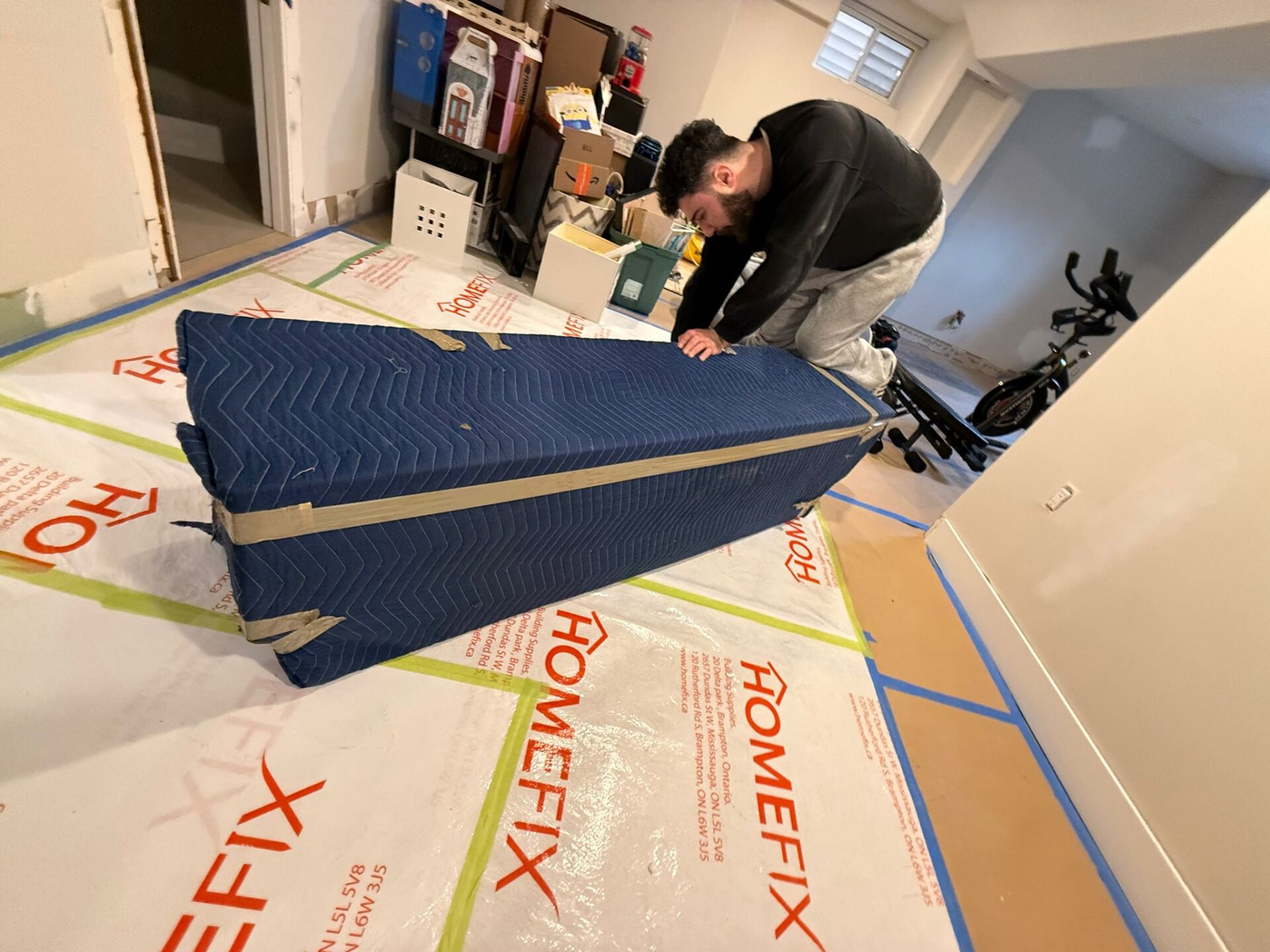 Ecoway Movers Guelph uniformed team packing fragile items carefully with bubble wrap and professional packing tape during Guelph home relocation