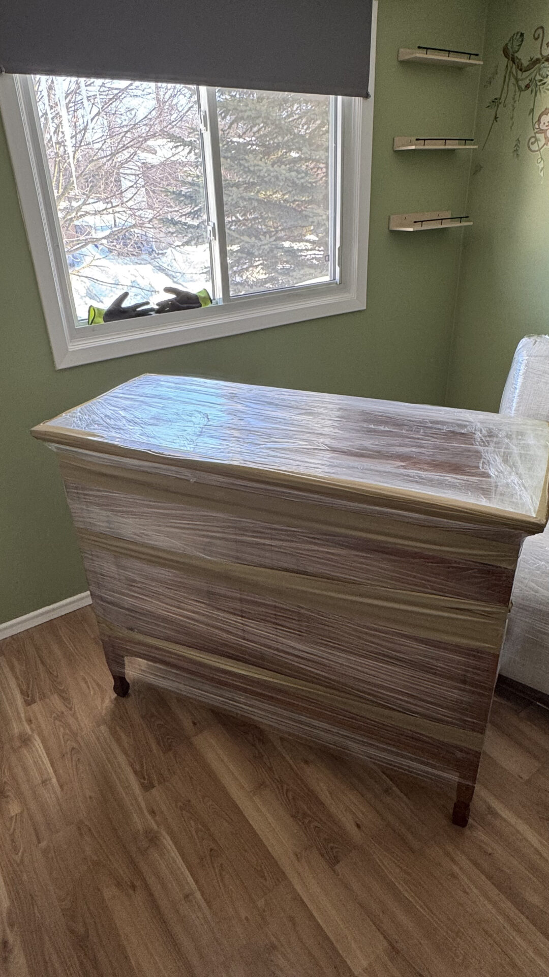 Ecoway Movers Saskatoon SK crew protecting wooden furniture with professional wrapping blankets during a residential relocation to prevent scratches and damage