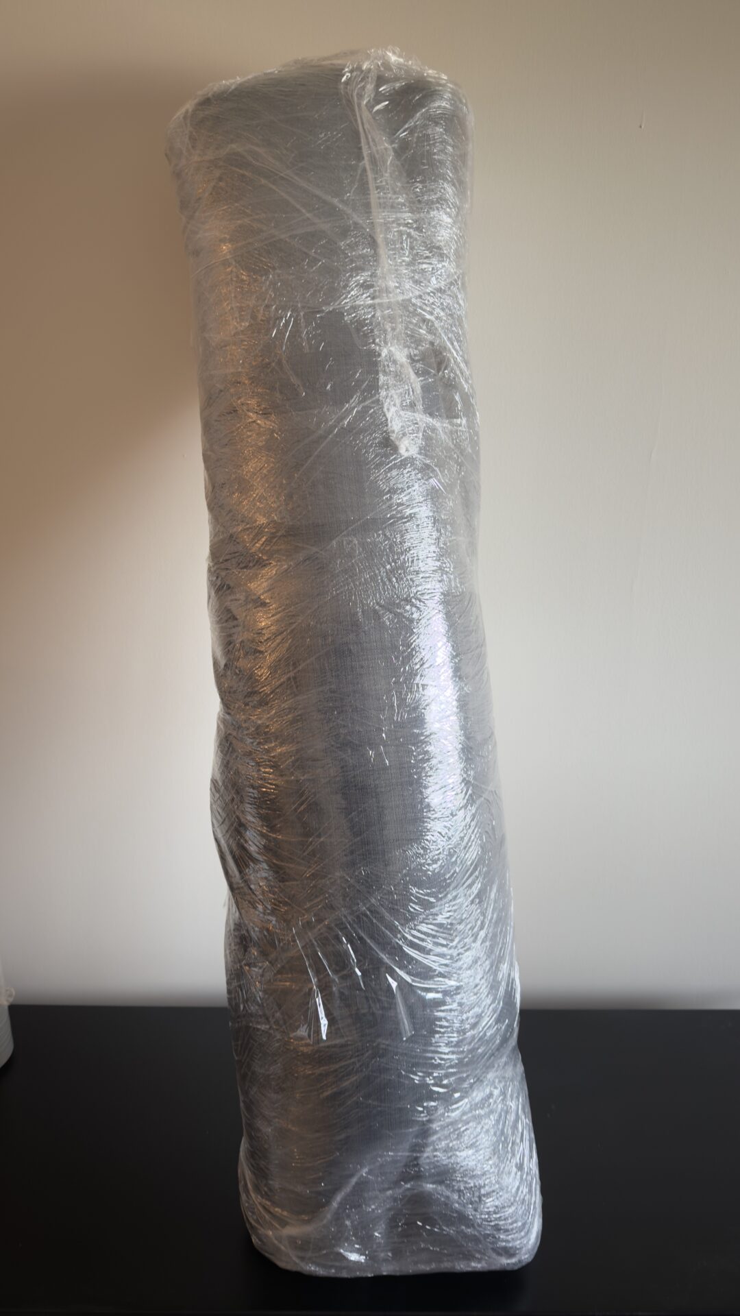 Ecoway Movers Vancouver BC team wrapping mattress with protective cover during Vancouver apartment move with floor protection in place