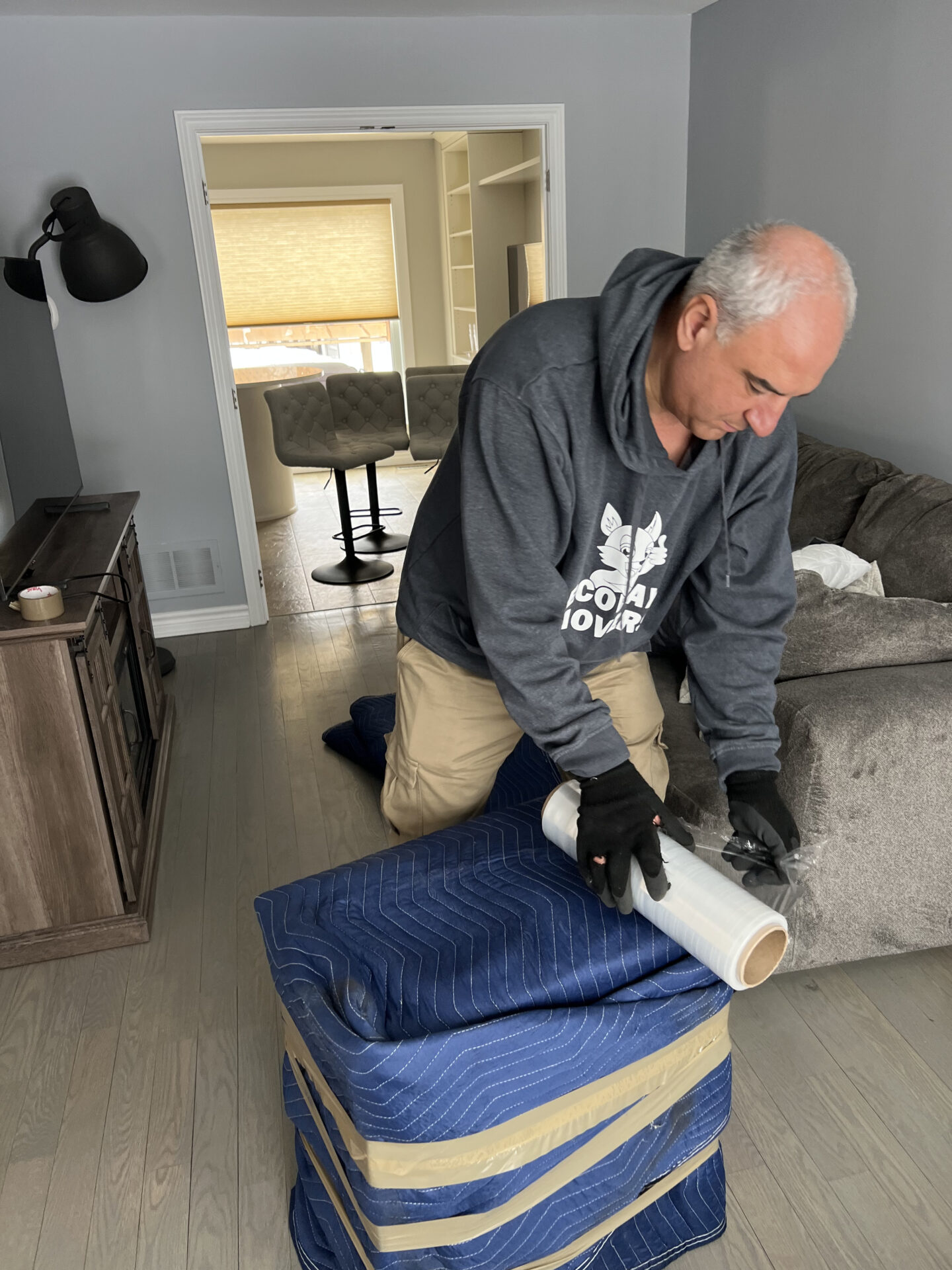 Ecoway Movers Vancouver BC full-service packing team systematically packing home contents for local Vancouver relocation with branded materials