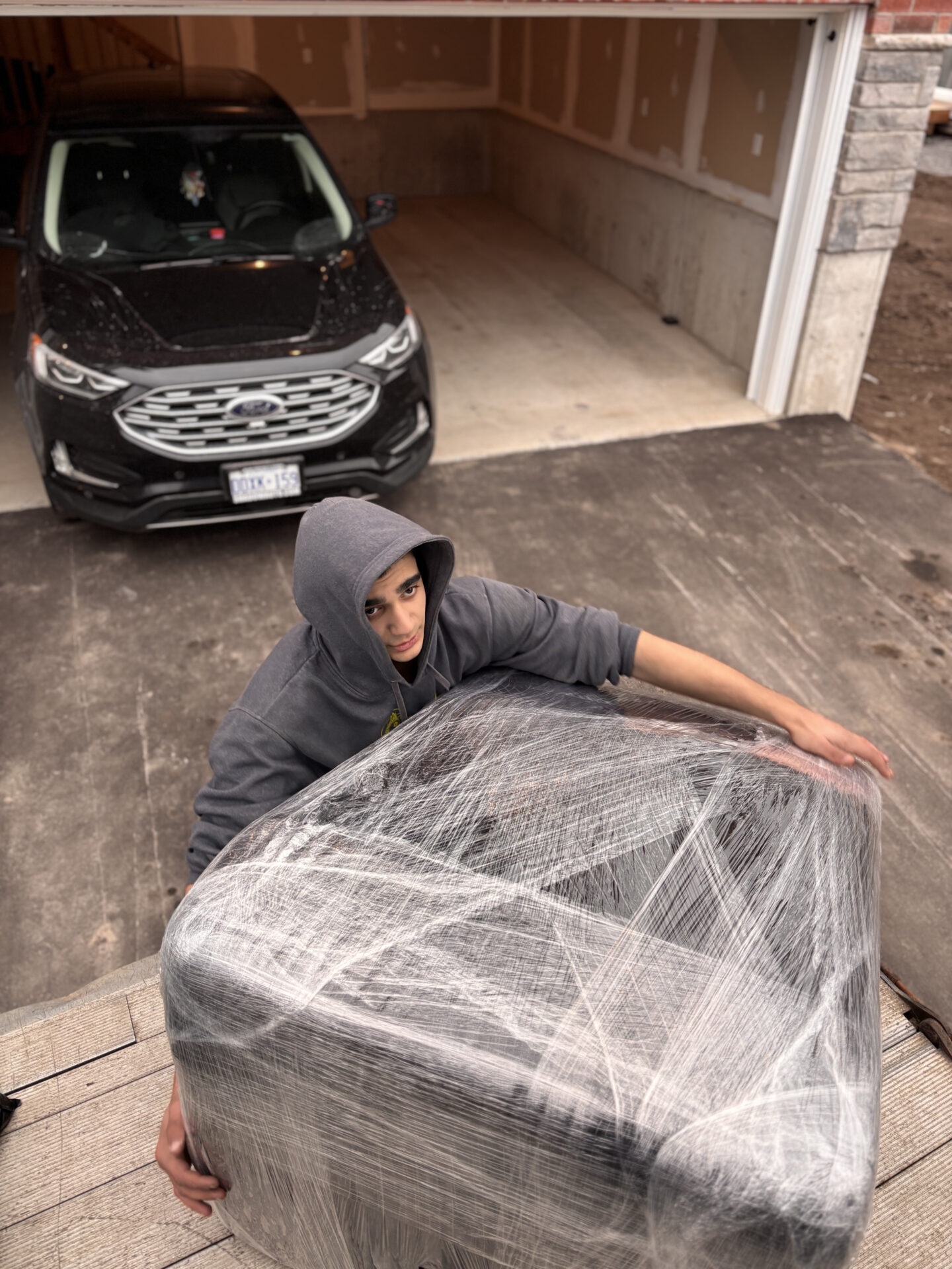Ecoway Movers crew performing residential move in Peterborough with branded truck and uniformed team
