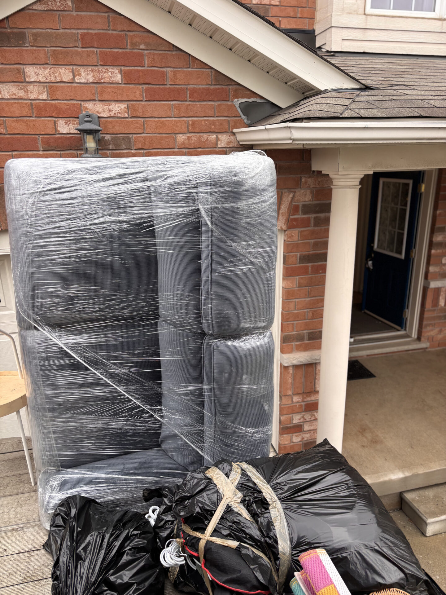 Ecoway Movers Innisfil team unloading professionally packed and wrapped furniture at destination home in Stroud Ontario