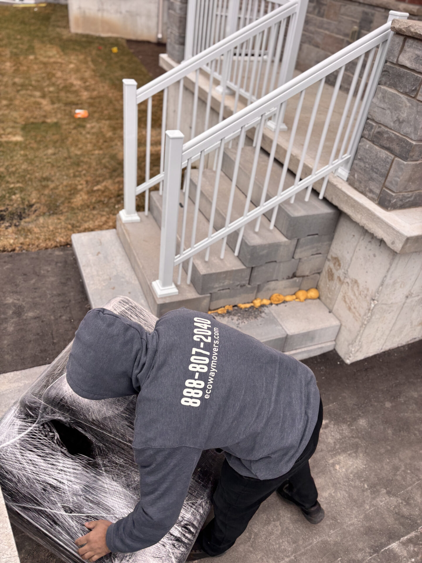 Ecoway Movers Regina SK vetted movers loading furniture onto truck using proper lifting technique and protective blankets during a local home move in Regina Saskatchewan
