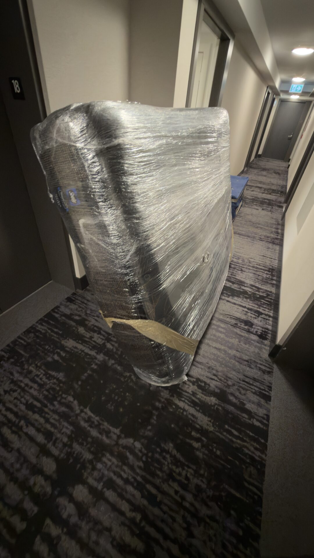 Ecoway Movers crew coordinating elevator during an Eau Claire condo move