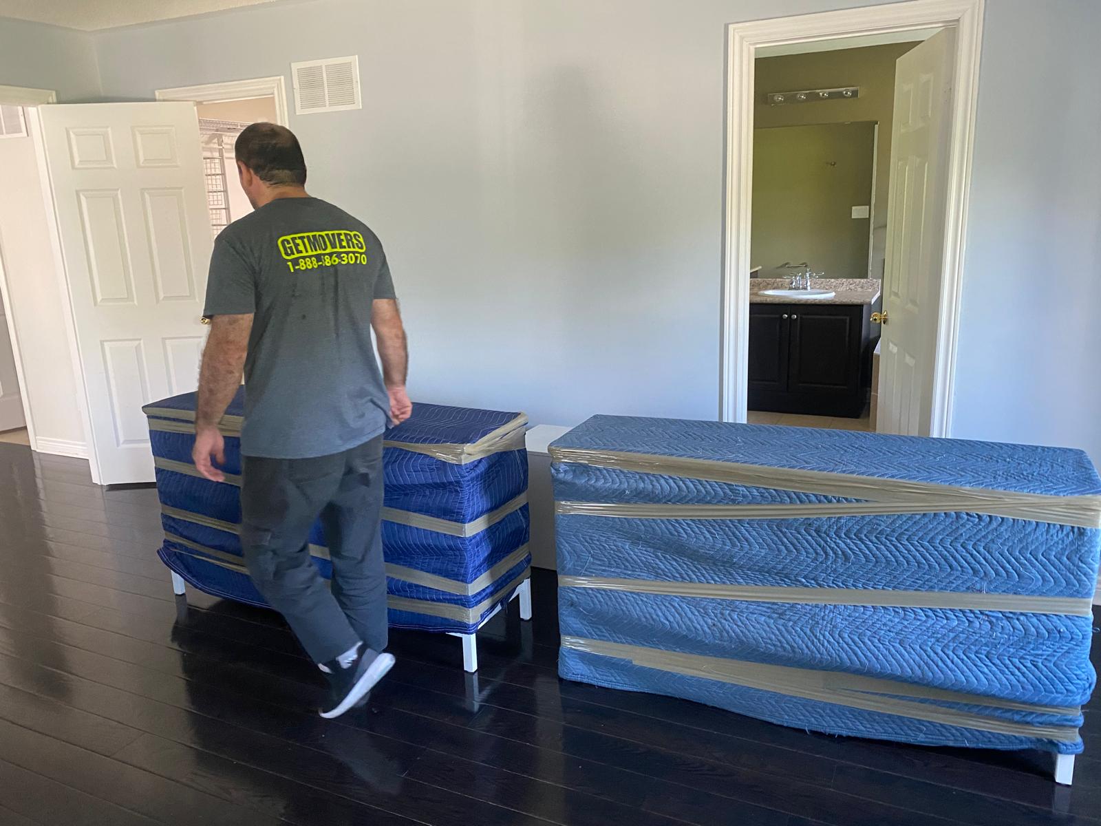 Get Movers Brampton ON crew safely extracting heavy furniture using industrial lifting straps in a Brampton property