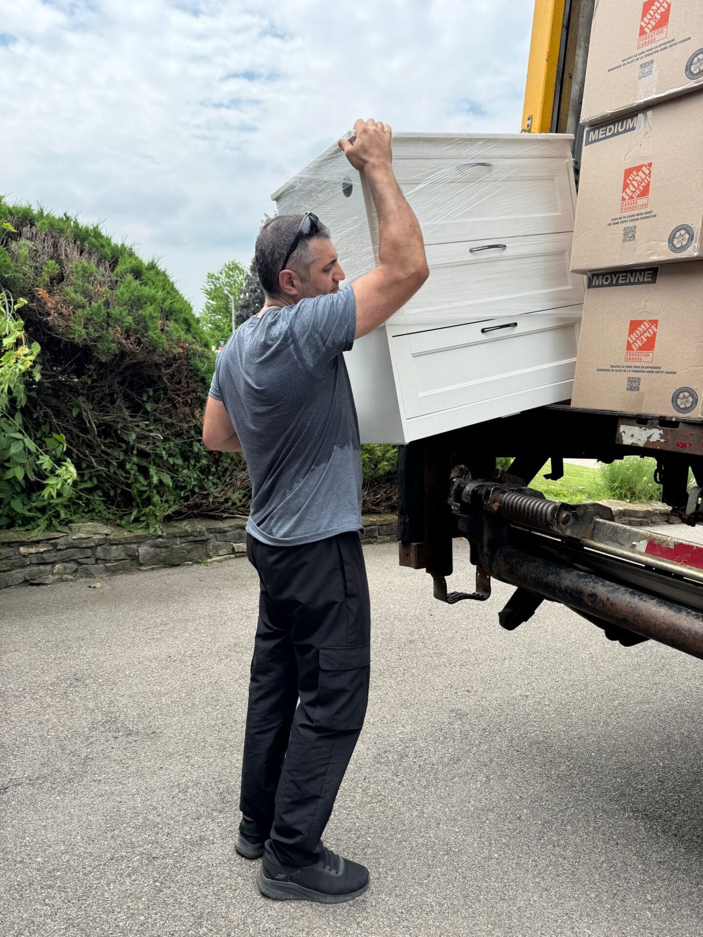 Ecoway Movers utilizing heavy-duty property protection protocols while loading a specialized moving truck on a residential street in Harrison, Milton