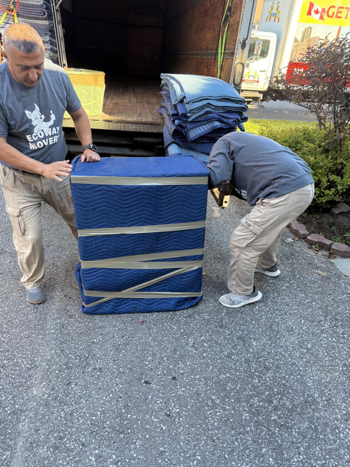 Movers safely transporting heavy specialized items in an Aurora townhouse