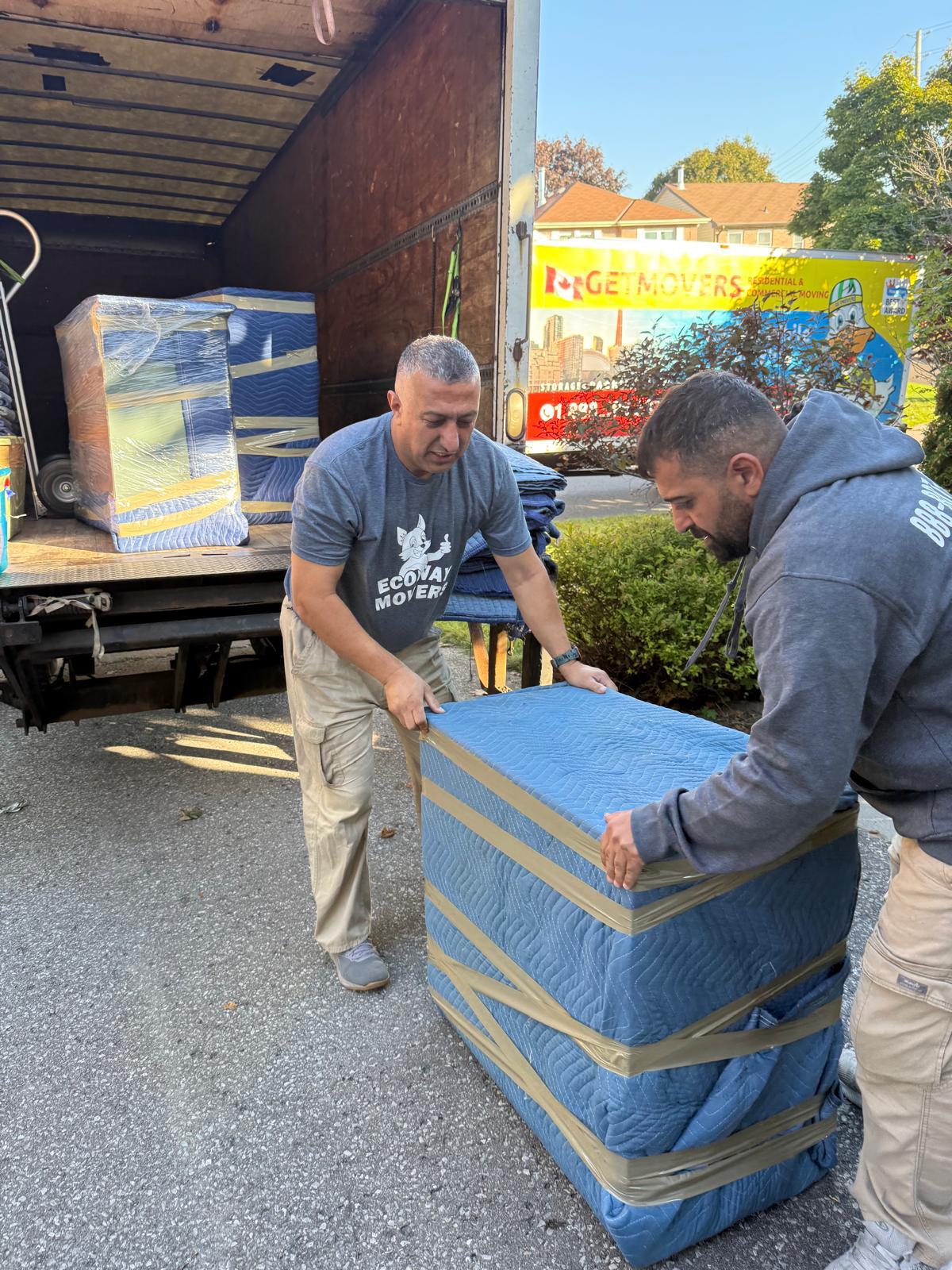 Ecoway Movers performing a residential move in Lansing North York with protective equipment for family furniture