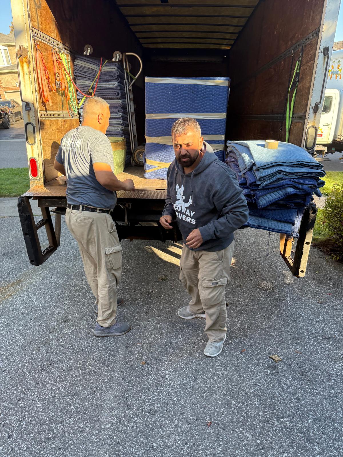 Professional Ecoway Movers team carefully packing high-value household items in a North York home