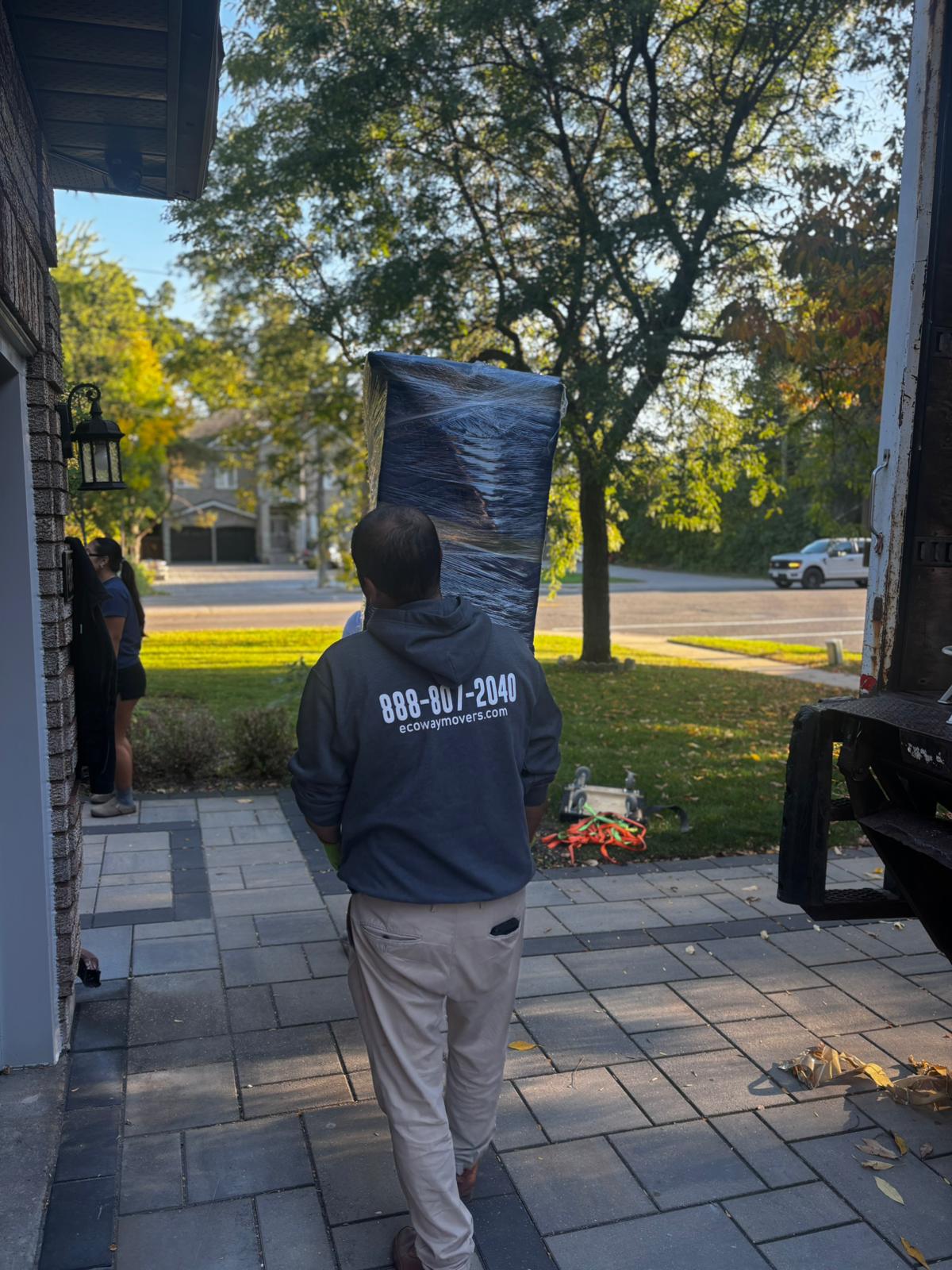 Ecoway Movers Newmarket certified crew member carefully wrapping a fragile item using professional packing materials during a Stonehaven Wyndham home relocation