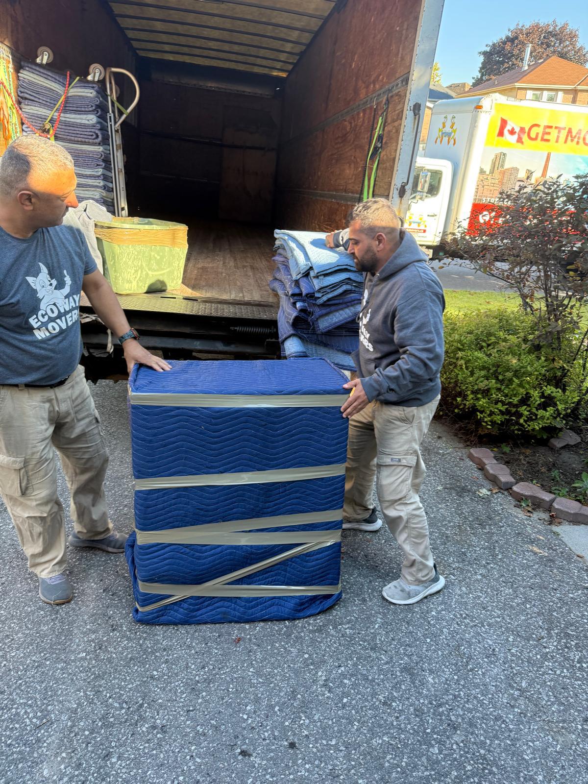 Ecoway Movers moving boxes into a Brampton home