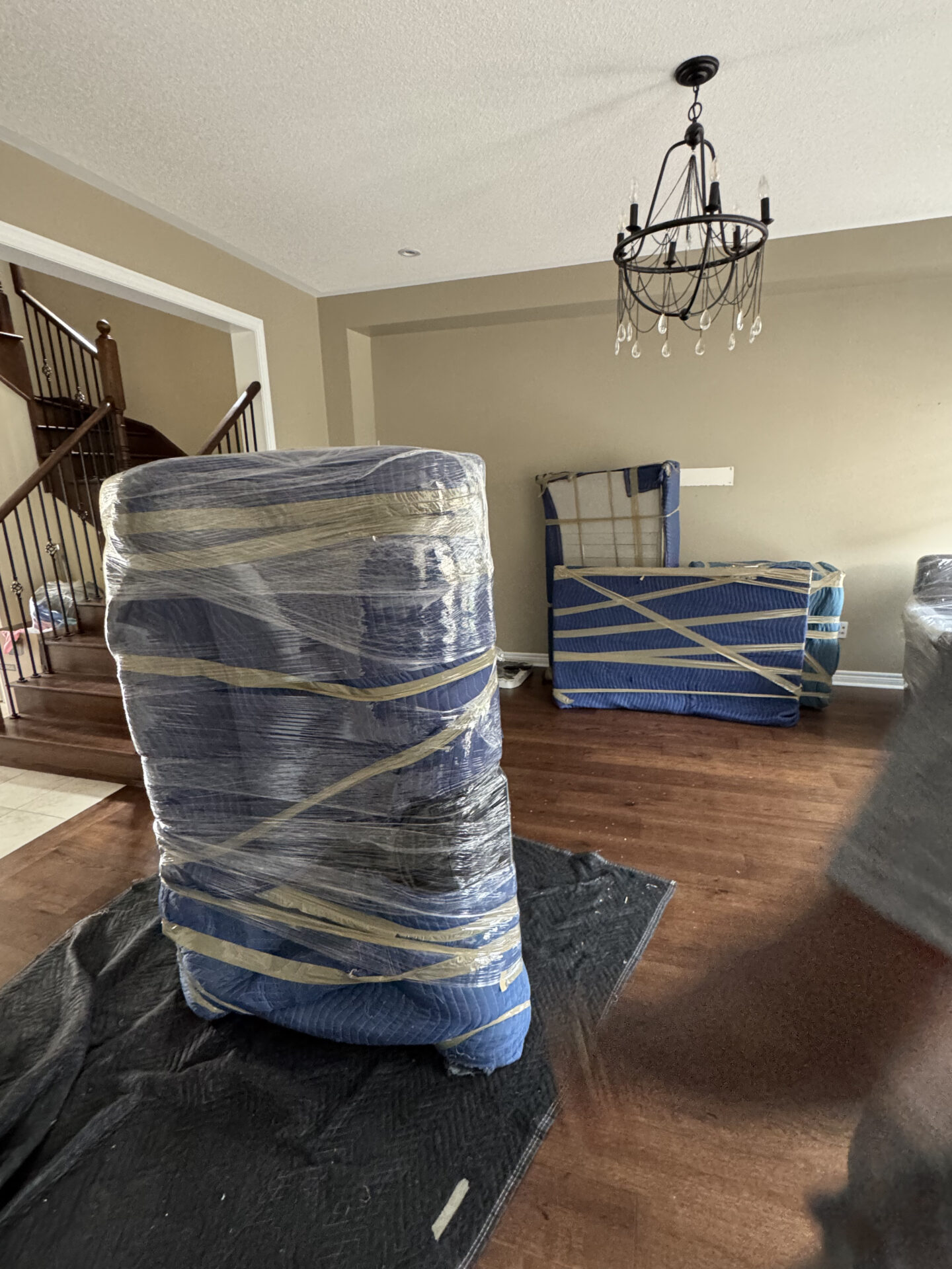 Ecoway Movers Cambridge team performing heavy furniture and appliance loading with stair-climbing equipment and furniture blanket protection