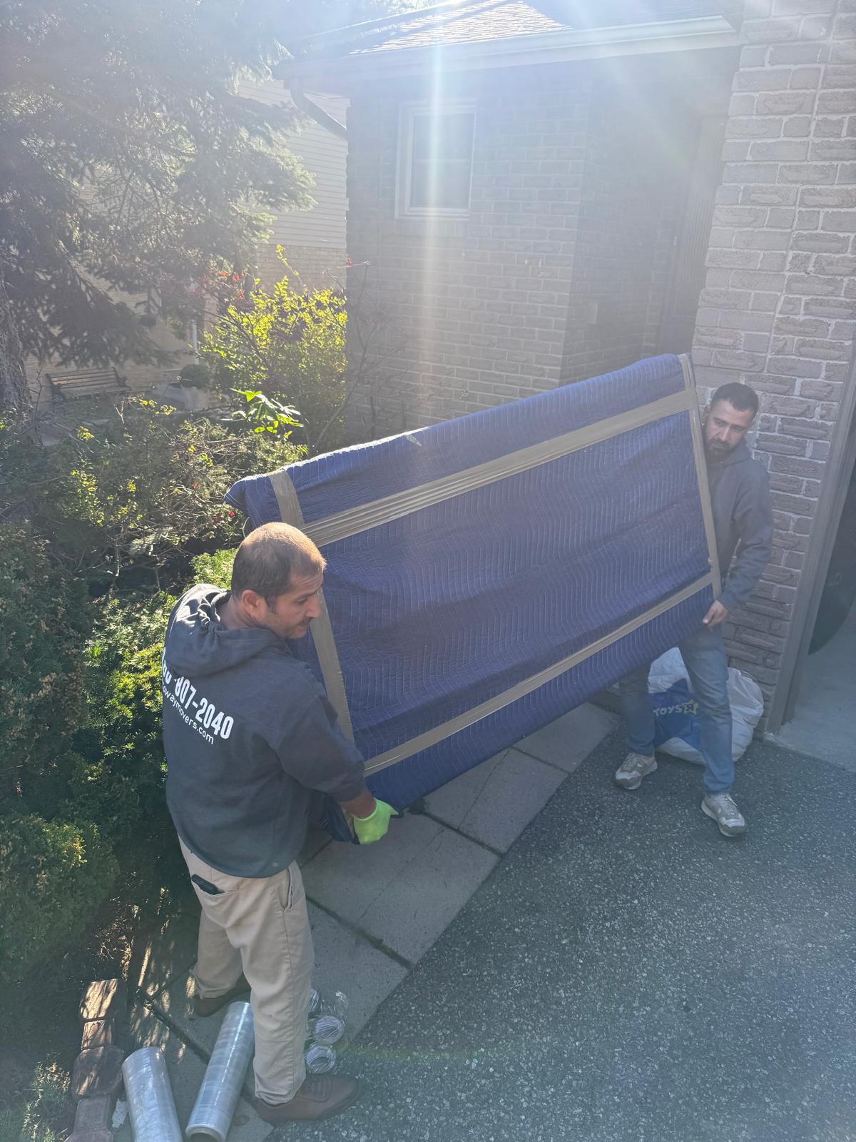 Ecoway Movers Ajax certified mover carefully handling belongings during local move in Durham Region demonstrating professional moving service standards