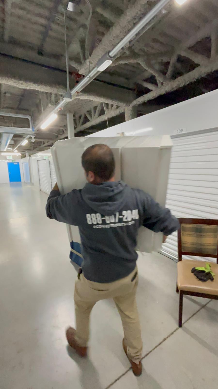 Ecoway Movers Newmarket certified crew member carefully carrying boxes during a residential relocation in Glenway Estates demonstrating professional handling protocol