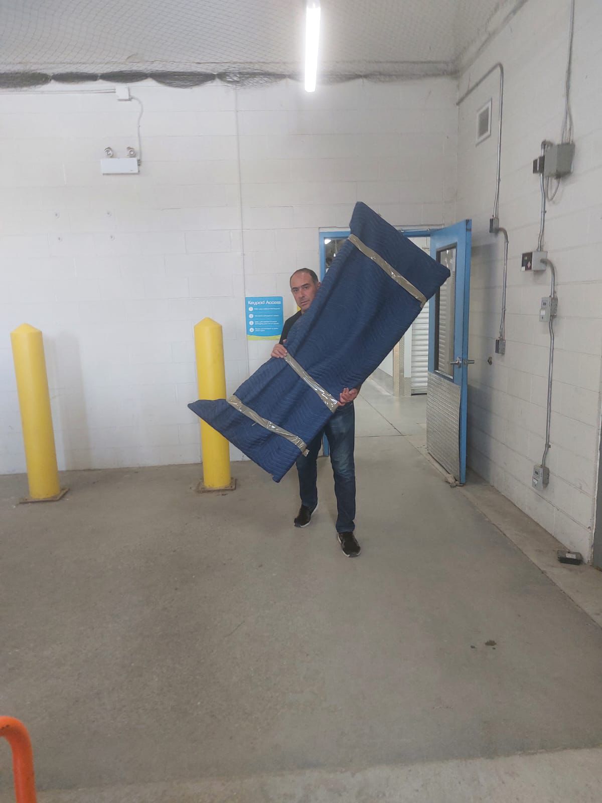 Ecoway Movers Ajax crew carefully moving furniture including table during local residential relocation in Ajax Ontario with floor protection